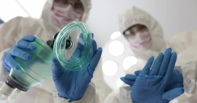 Doctors in protective suits providing resuscitation assistance to patient 4k movie. Emergency care for patients with covid 19 concept