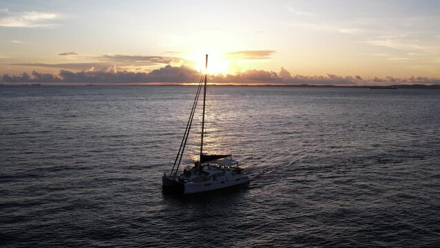 Sunset on the bay of all saints with sailboat silhouette in the foremost in Salvador Bahia Brazil