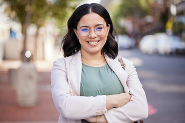 Happy, arms crossed and portrait of woman in city for corporate confidence, work and career. Smile, expert and a professional young female employee in the street or road for travel to the workplace