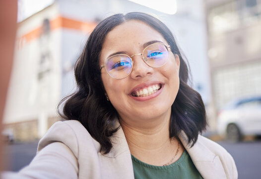 Young business woman, selfie and city with smile, glasses and excited for start to finance career in street. Employee, outdoor and happy with memory, photography and profile picture for social media