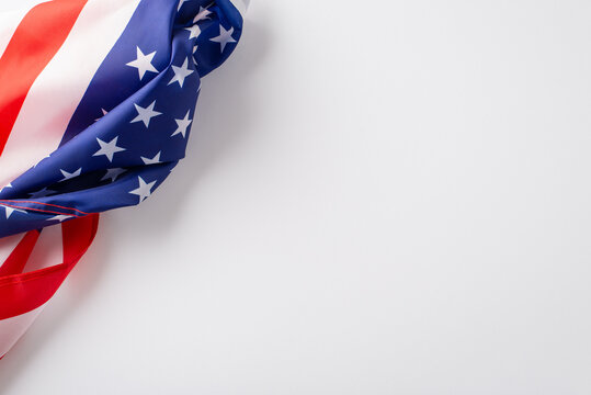 Honoring the significance of the public holiday: Engage your audience with this top-view image, featuring the American flag against white backdrop. Perfect for advertisements or text overlays