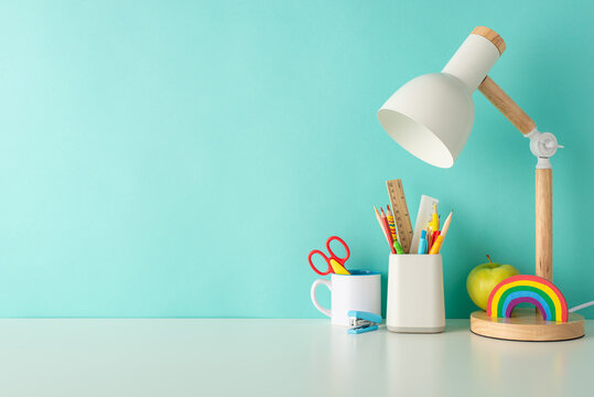 Cultivate Efficient Learning Habits With This Side-view Photo Featuring White Desk With Colorful Office Supplies, Organizer, And Lamp On A Blue Backdrop, Accompanied By Ample Space For Text Or Advert