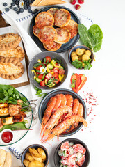 Family dinner or lunch. Many dishes on the table. Summer.