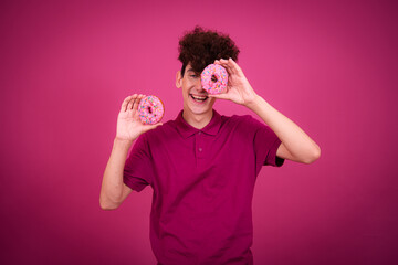 Sports and healthy lifestyle. Funny guy with tasty donuts for breakfast.