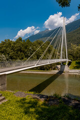 Modern pedestrian bridge in the middle of the mountains of Italian Switzerland, which allows you to cross the Ticino river.