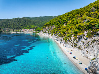 Aerial view of the beautiful Hovolo beach, Sporades, Greece, with turquoise sea and lush pine tree...