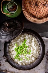 Wholesome Fusion: Top Close-Up of Edamame Served on Steamed White Rice in a Cast Iron Pot, Captured in 4K Resolution