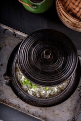 Wholesome Fusion: Top Close-Up of Edamame Served on Steamed White Rice in a Cast Iron Pot, Captured in 4K Resolution