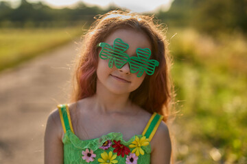 Funny Irish girl with red hair dressed as a fairy for St.Patricks Day festival on the 17th of March