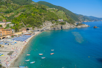 Fototapeta premium aerial view over beach chairs and umbrellas on the beach of Monterosso, Cinque Terre, The Ligurian Sea, Liguria, Italy, Italian Riviera