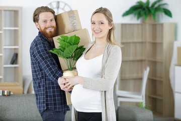 young couple moving to new flat with fragile things