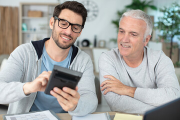 men crunching numbers working on finances