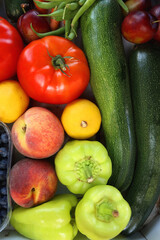 Wooden crate full of healthy colorful seasonal fruit and vegetable. Top view.