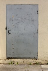 Old metal door painted with antistatic paint