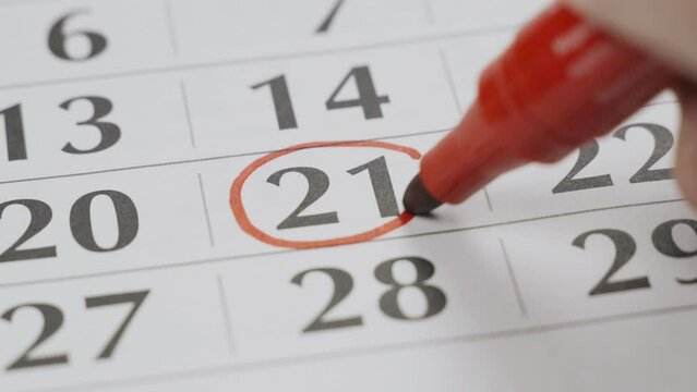 The twenty-first date on the calendar is boldly marked with a red marker as an important date. Close-up.