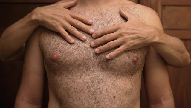 Close-up of a naked hairy man's body, which is touched by the male hands of another unrecognizable man 4K