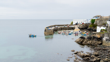 Traditional Cornish fishing boat at Coverack harbour with the tide out