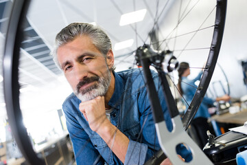 man posing and bike wheel