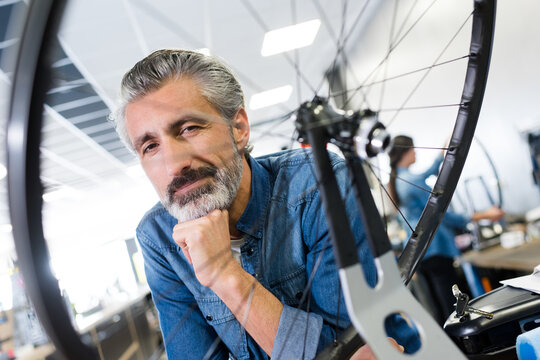 man posing and bike wheel