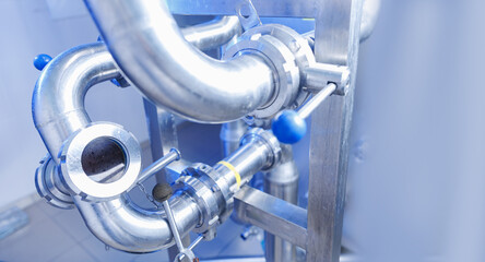 Pipes stainless steel brewing equipment, large reservoirs or tanks in modern beer factory. Brewery...