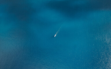 Aerial view of boat crossing the ocean
