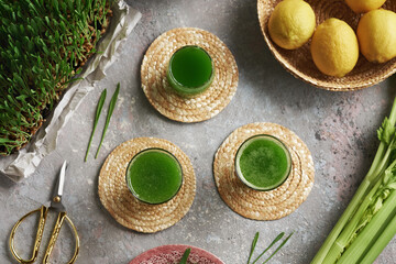 Three glasses of homemade barley grass juice with celery and lemon