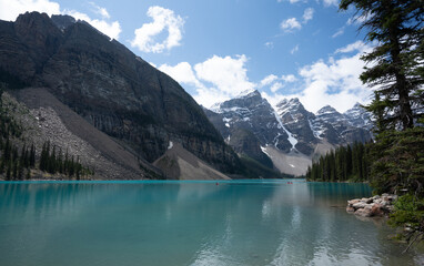 Beautiful glacial mountain lake with snow capped mountains