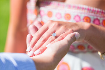 Obraz na płótnie Canvas wedding engagement ring hand finger index digit human skin diamond luxury precious