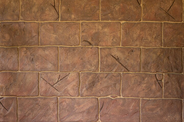 Brown stone wall with cracks