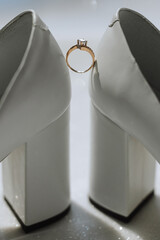 Close up of a gold ring with a diamond. Love, relationship and wedding concept. Soft and selective focus. Free space