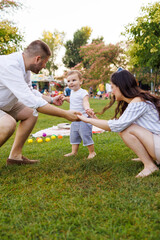 Mother and father playing with their child in the park