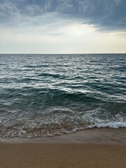 Sea before a storm. Sand beach. Mediterranean sea. Spain, Pineda de Mar. Sunset at sea. Seascape.