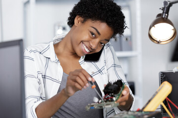 happy young woman fixing a pc