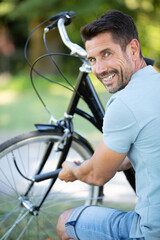 biker pausing to pump bike wheel
