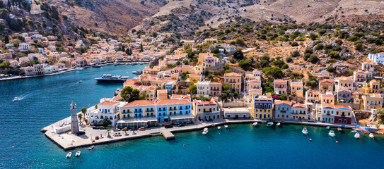 Aerial view of the beautiful greek island of Symi (Simi) with colourful houses and small boats....