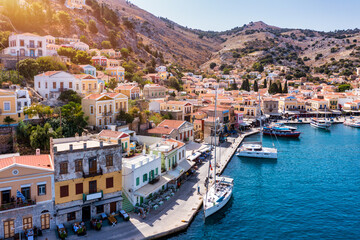 Aerial view of the beautiful greek island of Symi (Simi) with colourful houses and small boats. Greece, Symi island, view of the town of Symi (near Rhodes), Dodecanese. - 627754283