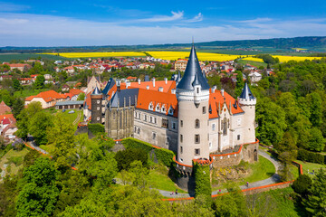Aerial view of Zleby castle in Central Bohemian region, Czech Republic. The original Zleby castle was rebuilt in Neo-Gothic style of the chateau. Chateau Zleby, Czechia. - obrazy, fototapety, plakaty