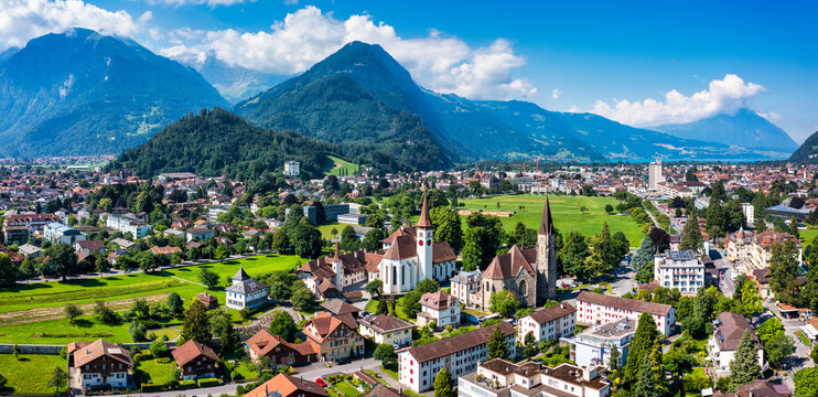 Aerial view over the city of Interlaken in Switzerland. Beautiful view of Interlaken town, Eiger, Monch and Jungfrau mountains and of Lake Thun and Brienz. Interlaken, Bernese Oberland, Switzerland.