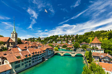 Fototapeta na wymiar View of the Bern old city center and Nydeggbrucke bridge over river Aare, Bern, Switzerland. Bern old town with the Aare river flowing around the town on a sunny day, Bern, Switzerland.