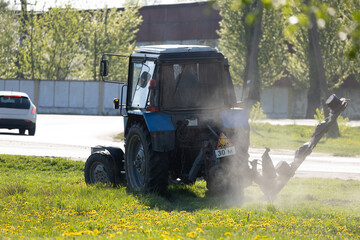 Agricultural tractor on the grass on a sunny day