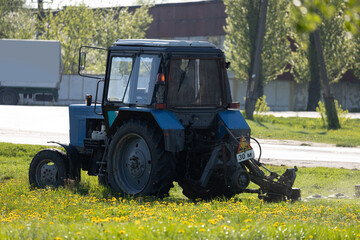Agricultural tractor on the grass on a sunny day