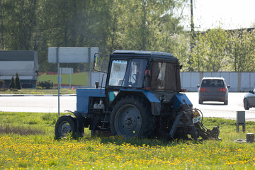 Agricultural tractor on the grass on a sunny day