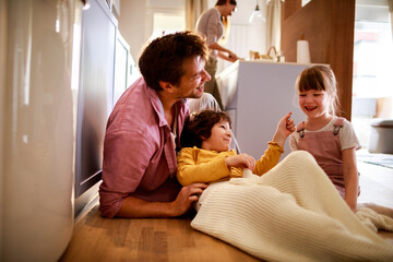 Young family being playful and having fun in the living room at home