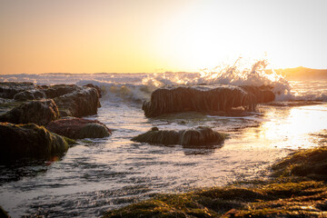 Sunset waves crashing on rocks in the pacific ocean La Jolla San Diego California coast