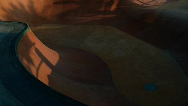 Video skateboard in a skate park at sunset