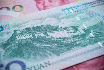 Potala palace, Tibet in back side of 50 Chinese paper currency Yuan renminbi banknotes background. China or economy of Asia growth, financial business, US trade war, Forex trading concept.