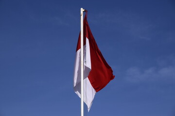 indonesian flag with blue sky