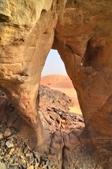 A natural arch formed in sandstone in the Sahara Desert in Algeria