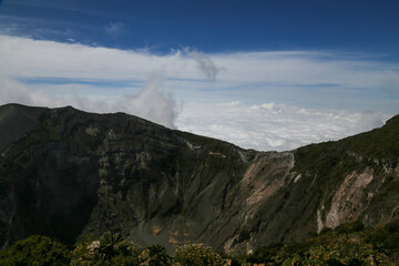 Volcanic landscape on the top of the crater with clouds at the Irazú Volcano National Park