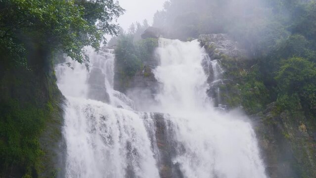 Ramboda Falls. Sri Lanka. Powerful stream of water in rocky mountains.